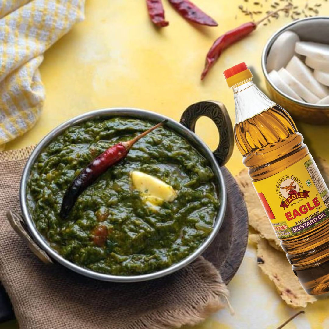 A bowl of sarson ka saag, a traditional North Indian dish made with finely chopped mustard greens and spinach, seasoned with Indian spices and tempered with cumin seeds and asafoetida, served with makki ki roti and a dollop of butter on top."